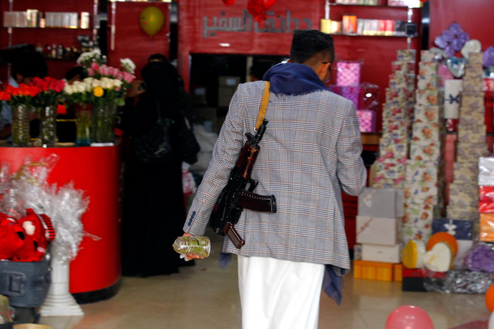 Uzbrojony obywatel Jemenu przechodzi przez sklep z prezentami walentynkowymi.