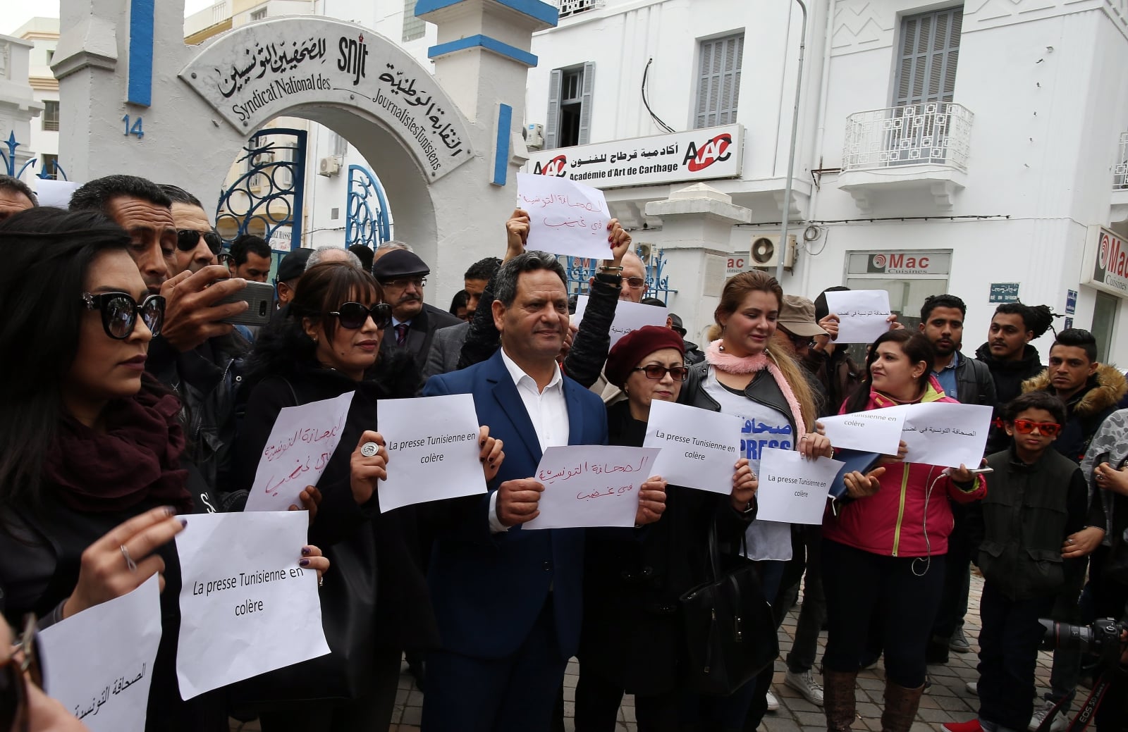 epa06492185 Tunisian journalists wearing red armbands hold signs reading in Arabic and French 'the Tunisian press is angry' during a protest outside the headquarters of the National Union of Tunisian Journalists (SNJT) in Tunis, Tunisia, 02 February 2018. According to reports, journalists gathered to protest against what they describe as 'threats and intimidation' by authorities against those covering security operations or being critical of state institutions.  EPA/MOHAMED MESSARA 
Dostawca: PAP/EPA.