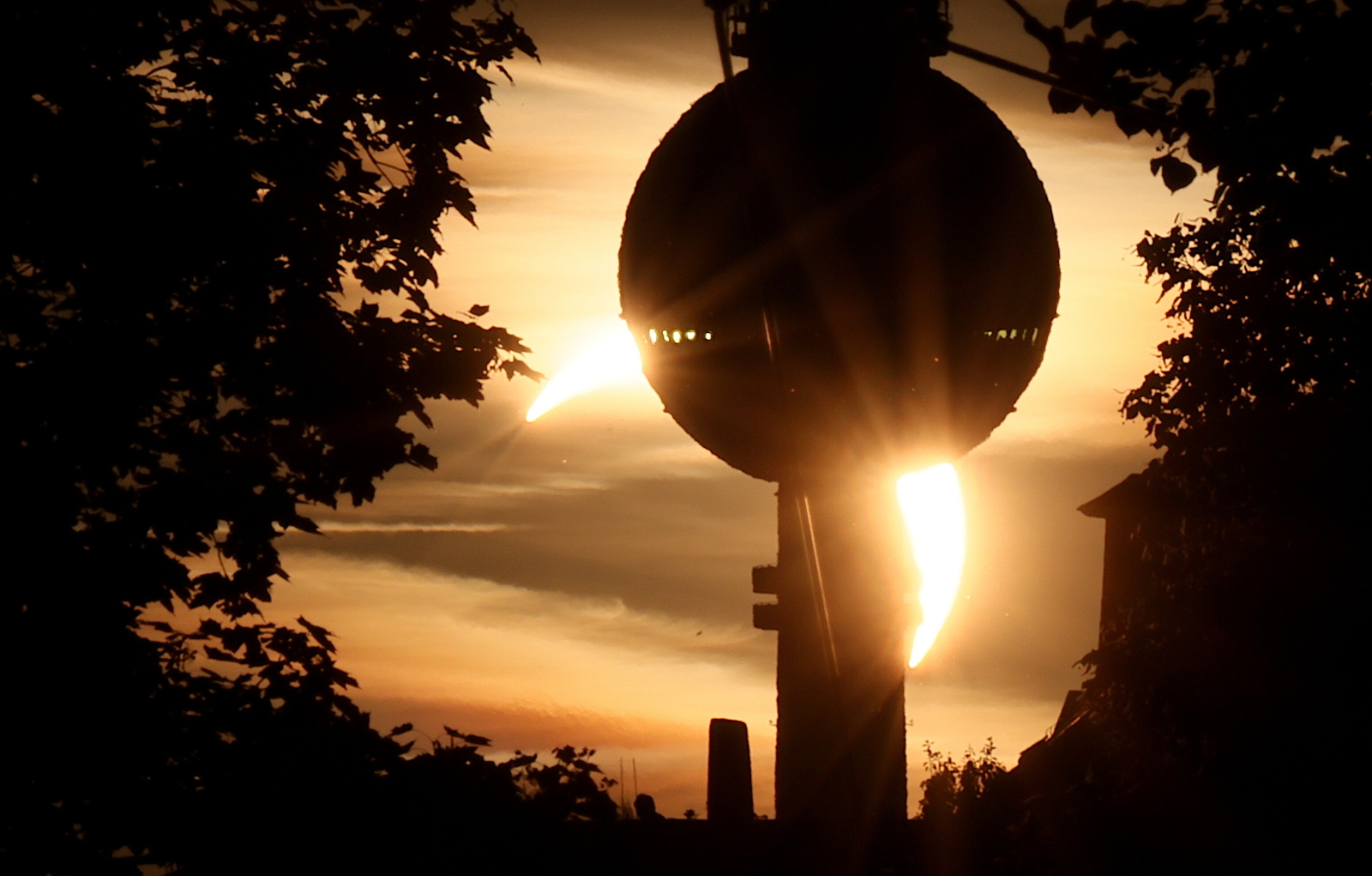 epa13164403 A part of the Sun obscured by the Moon during a partial solar eclipse is seen behind the TV tower in Berlin, Germany, 12 August 2026. A total solar eclipse will sweep across parts of Europe and the North Atlantic on 12 August, with the path of totality moving through Greenland, Iceland, Spain, and a small section of northeastern Portugal, while surrounding areas across Europe experience a partial solar eclipse, according to the European Space Agency (ESA). EPA/HANNIBAL HANSCHKE Dostawca: PAP/EPA.
